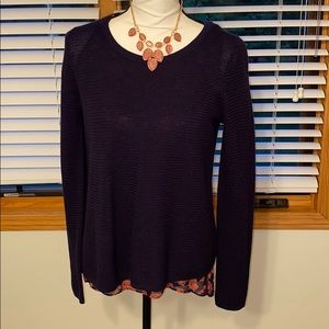 Part sweater and part blouse.